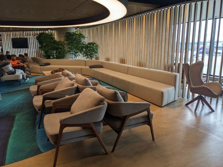 a room with a couch and chairs
