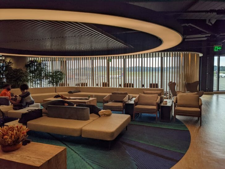a room with a large couch and chairs