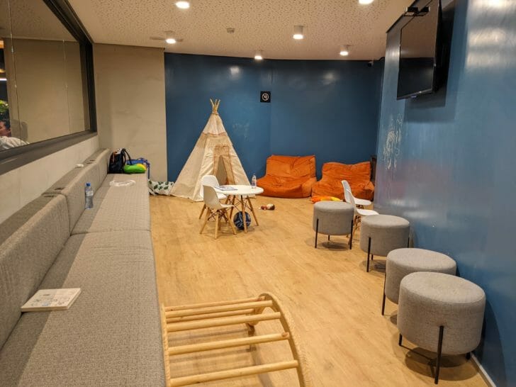 a room with a couch and chairs