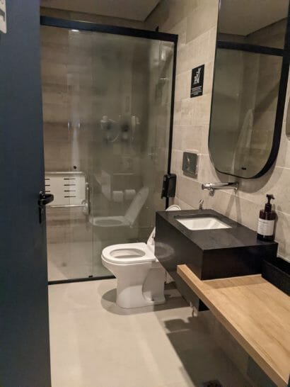 a bathroom with a glass shower and sink