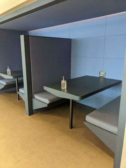 a booth seating with a couple of tables