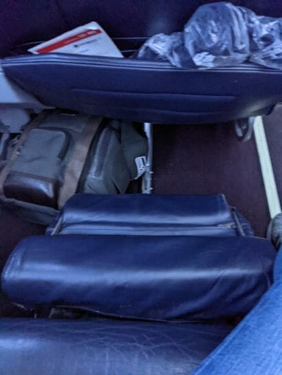a group of luggage in the back of an airplane