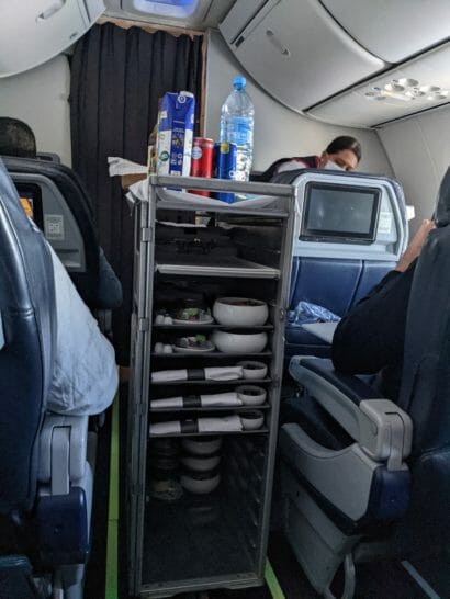 a shelf with food and drinks on it in an airplane