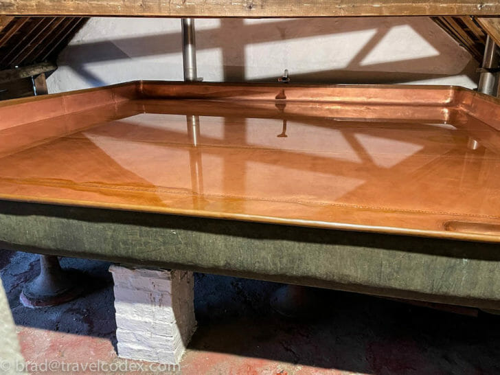 a copper tray on a green surface
