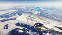 an airplane flying over the mountains