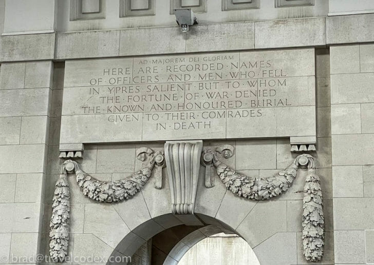 a stone archway with a sign