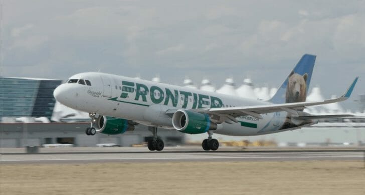 a white and green airplane on a runway