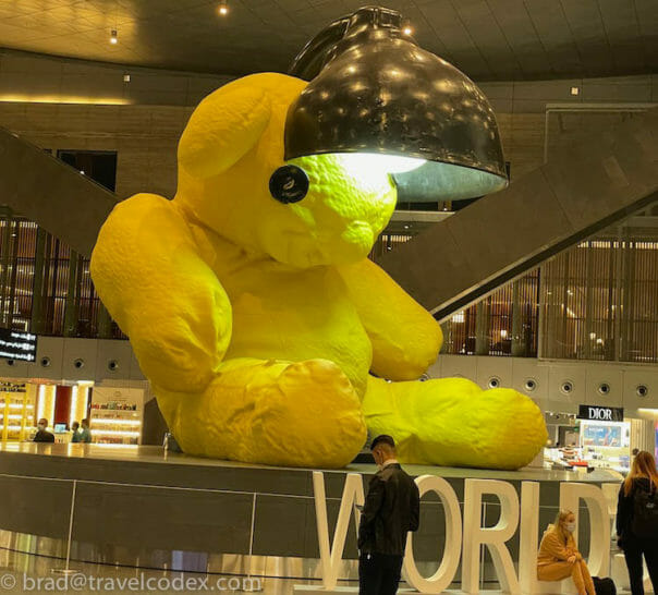 a large yellow teddy bear with a lamp