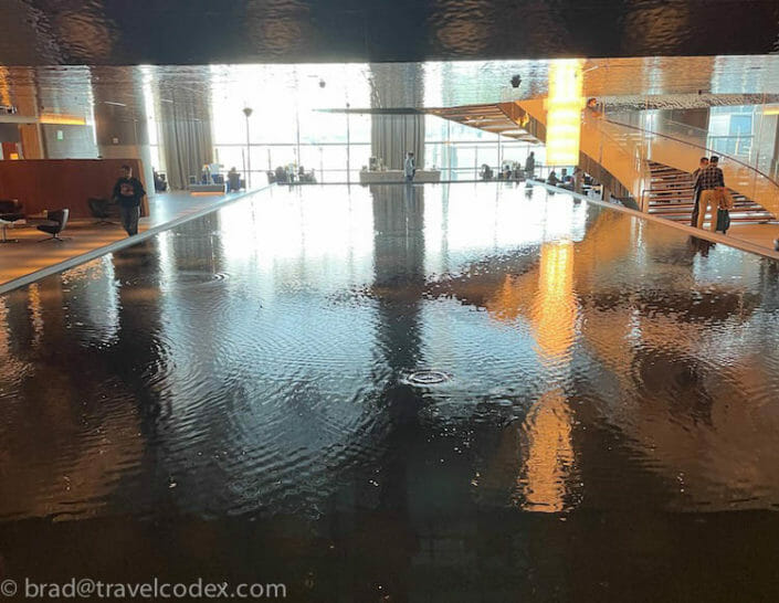 a large flooded floor with a staircase and a large window