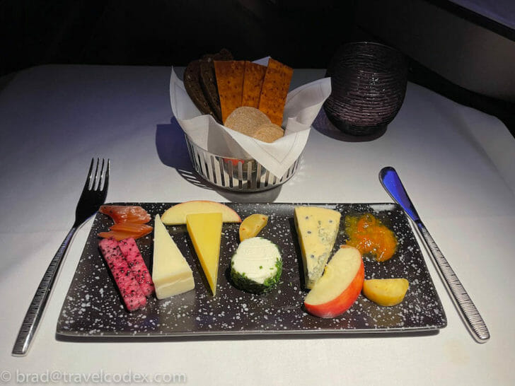 a plate of cheese and fruit on a table