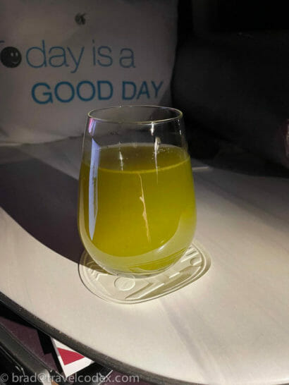 a glass of yellow liquid