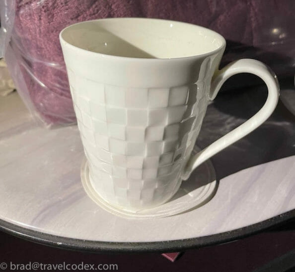 a white cup on a plate