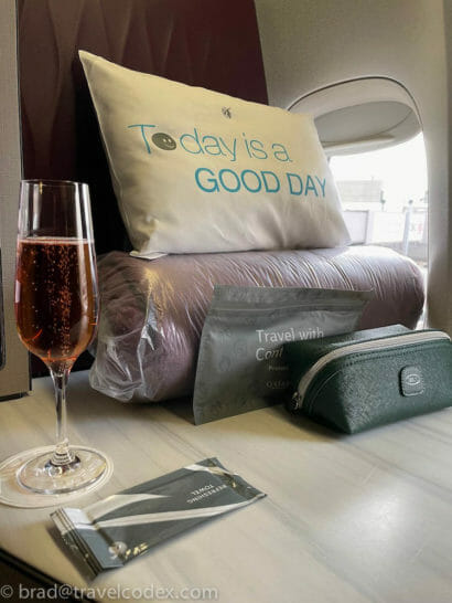 a glass of champagne next to a pillow
