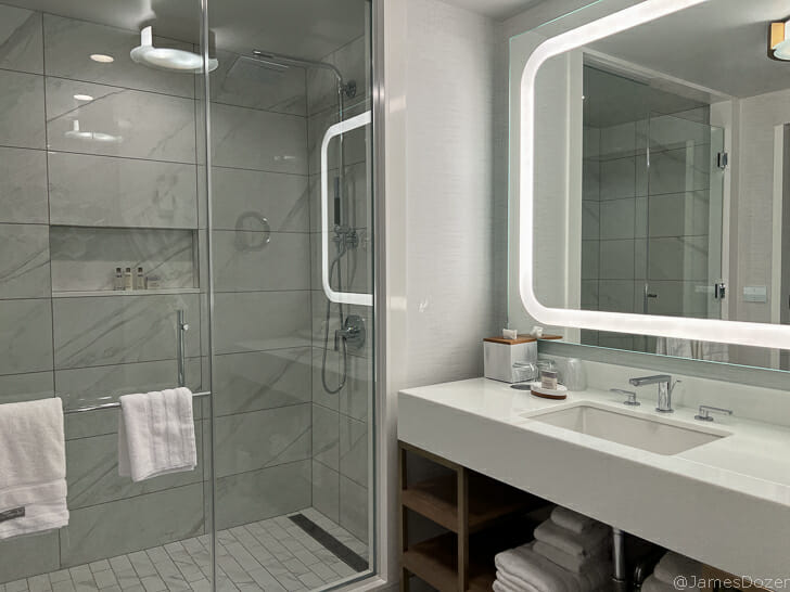 a bathroom with a glass shower and sink