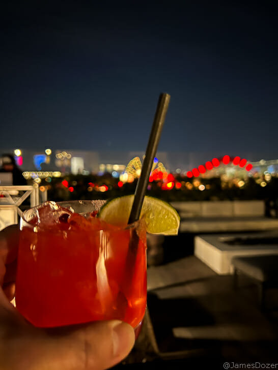 a hand holding a drink with a straw