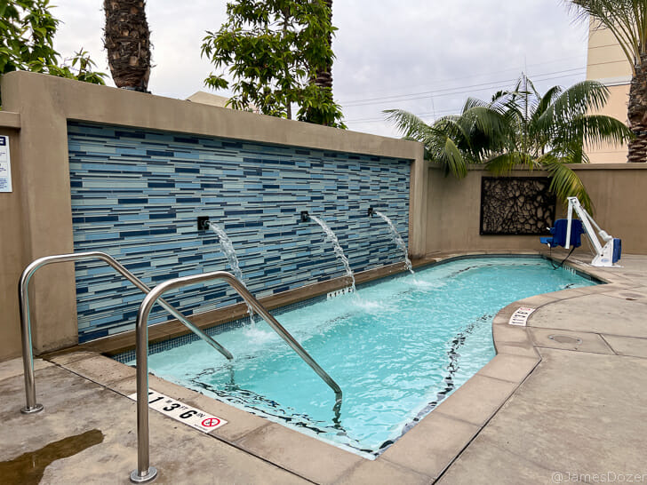 a pool with water jets and a wall