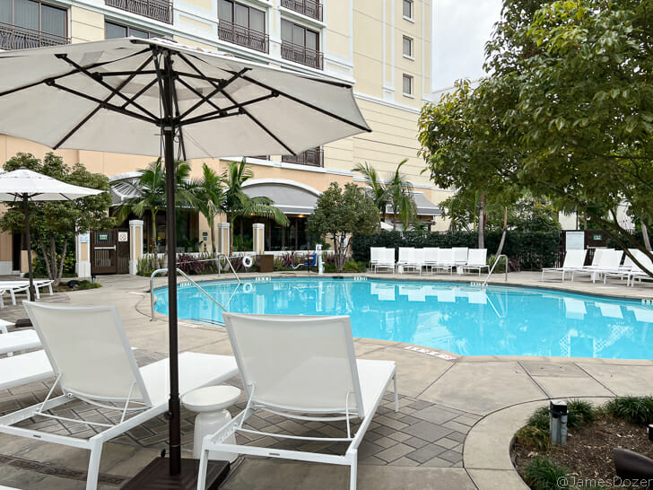 a pool with chairs and umbrellas