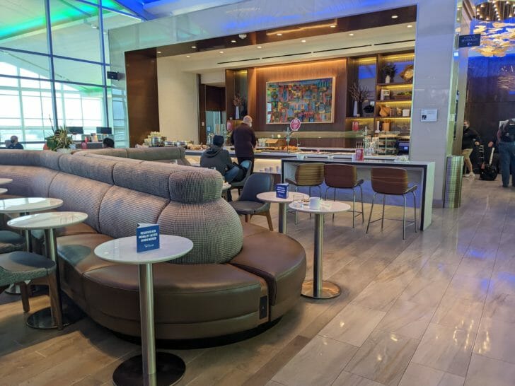 a room with a large couch and tables