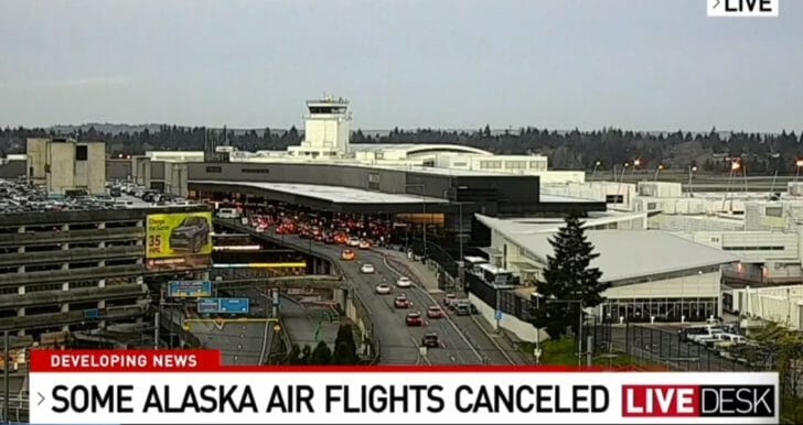 a large airport with cars on the road