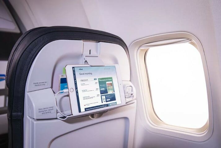 a tablet on the seat of an airplane