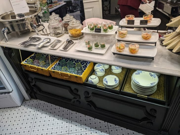 a buffet table with plates and bowls