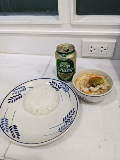 a plate of rice and a can of beer