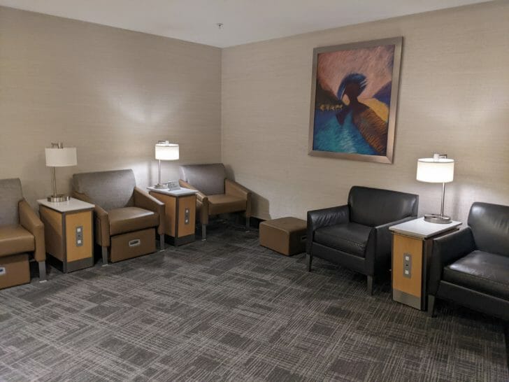 a room with chairs and a painting