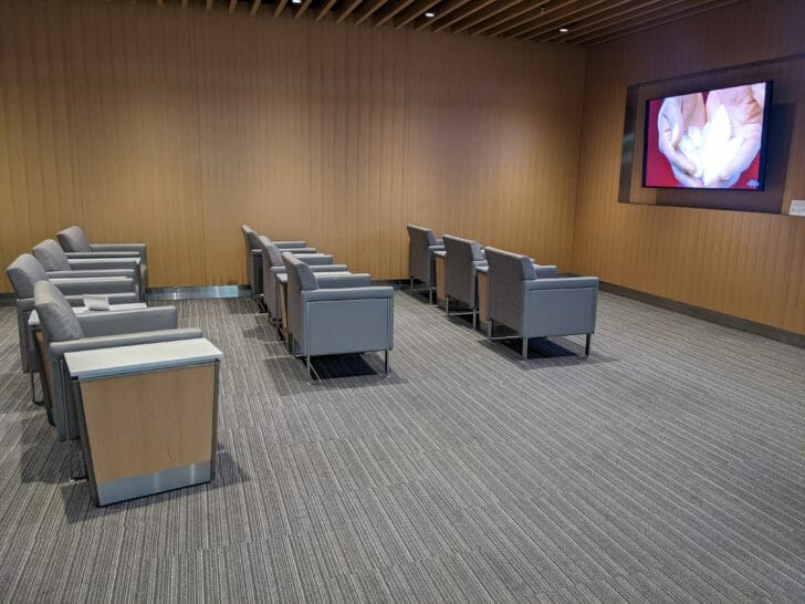 a room with chairs and a screen