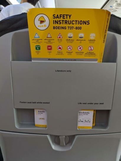 a yellow and black sign in a grey object