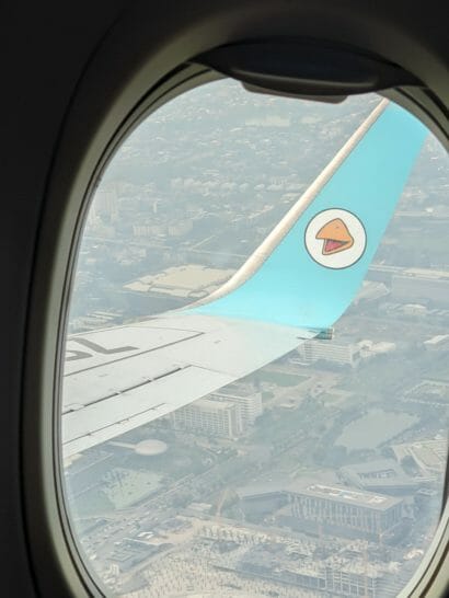 an airplane wing with a logo on the wing