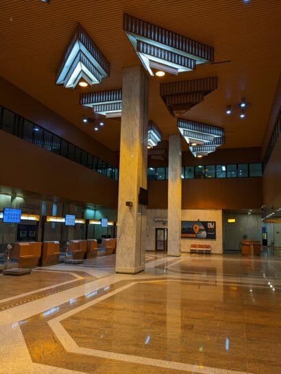 a large hall with a marble floor and a large pillar