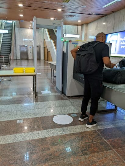 a man standing at a baggage claim machine