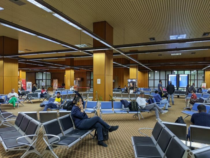 people sitting in chairs in a terminal