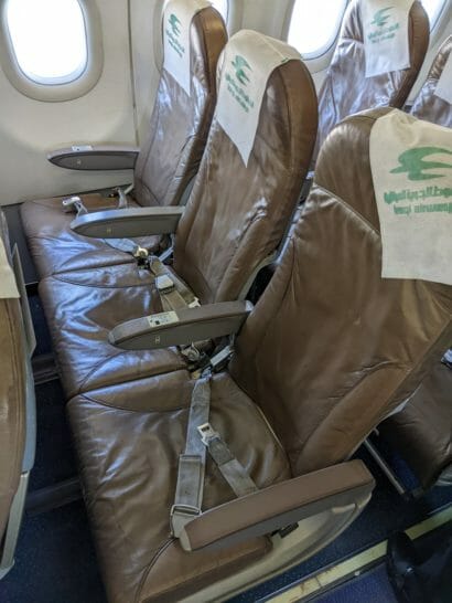 seats in an airplane with a seat belt