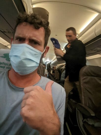a man wearing a mask and giving a thumbs up