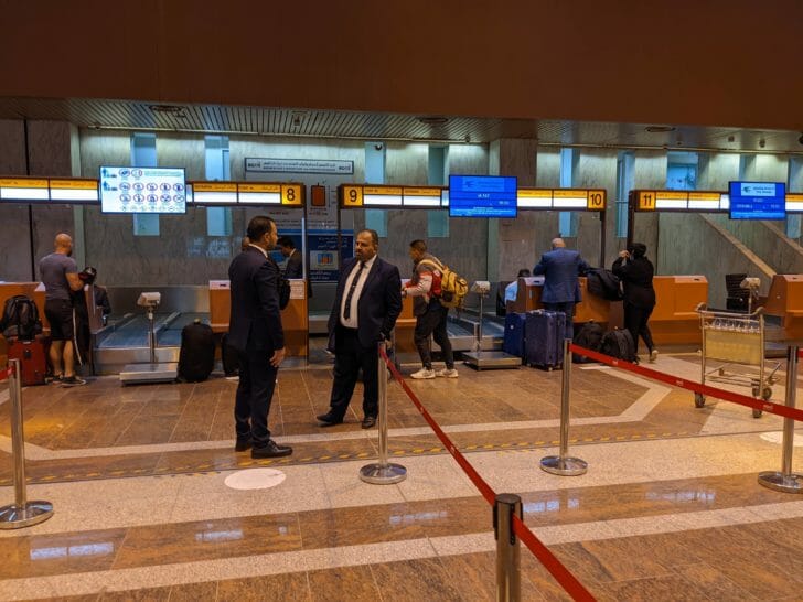 people in a room with luggage
