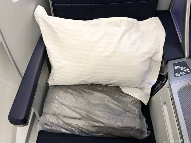 a pillow and a plastic bag on a seat