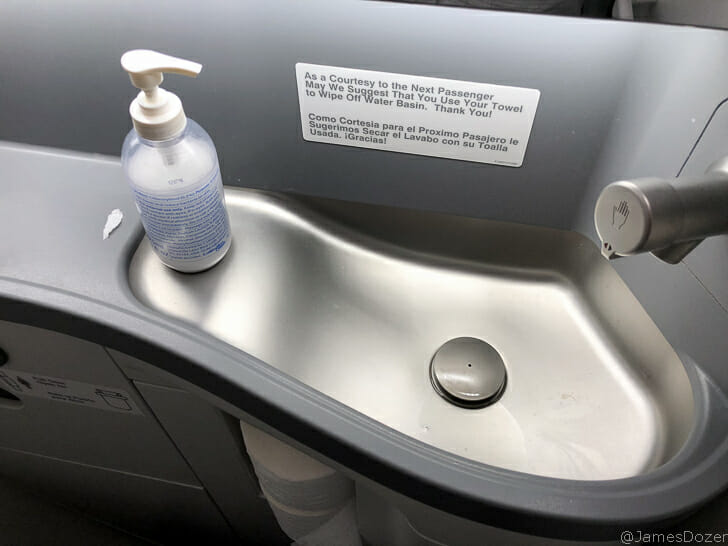 a sink with a bottle of liquid on it