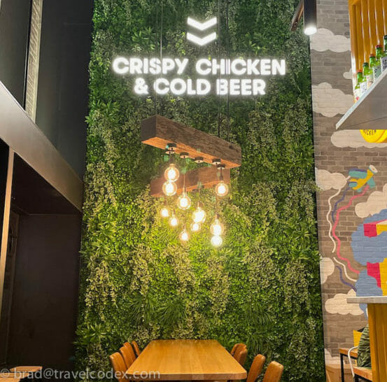 a green wall with a table and chairs