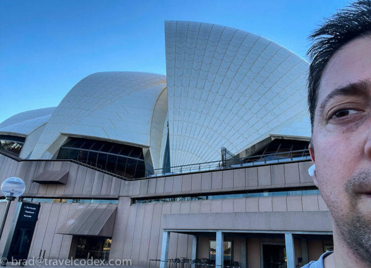 a man taking a selfie in front of a building
