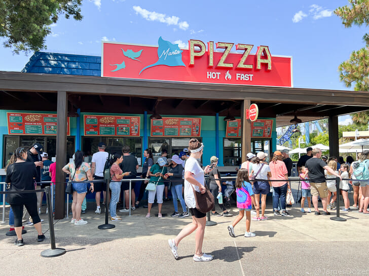 a group of people outside a pizza restaurant
