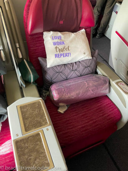 a seat with pillows and a pillow on it