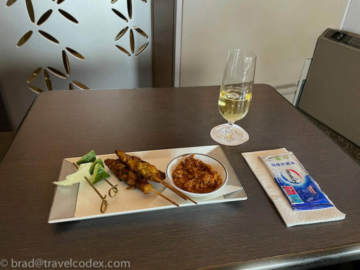 a plate of food and a glass of wine