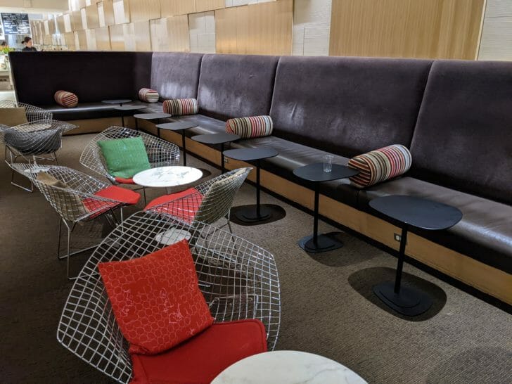 a long couch with tables and chairs