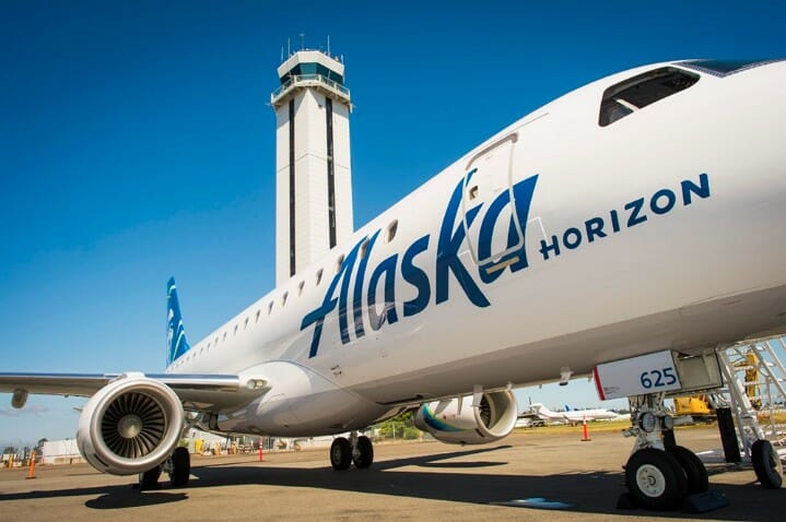 a white airplane with blue writing on it