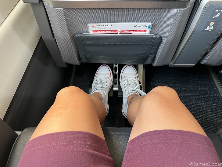 a person's legs in white shoes