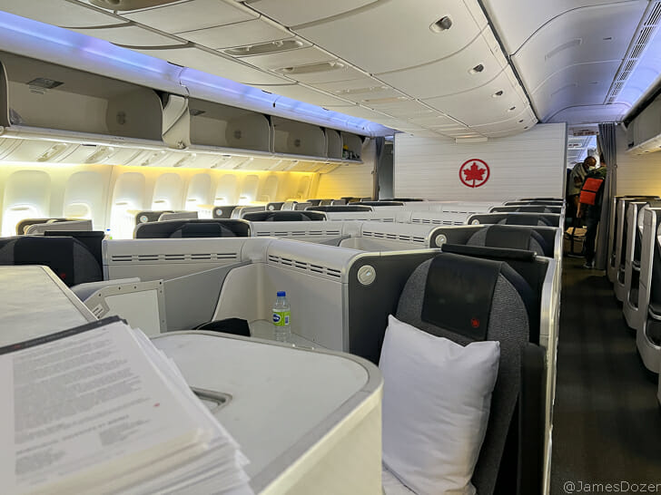 a plane with many seats and a couple of pillows