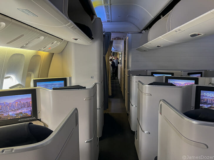 a row of seats with monitors on the side