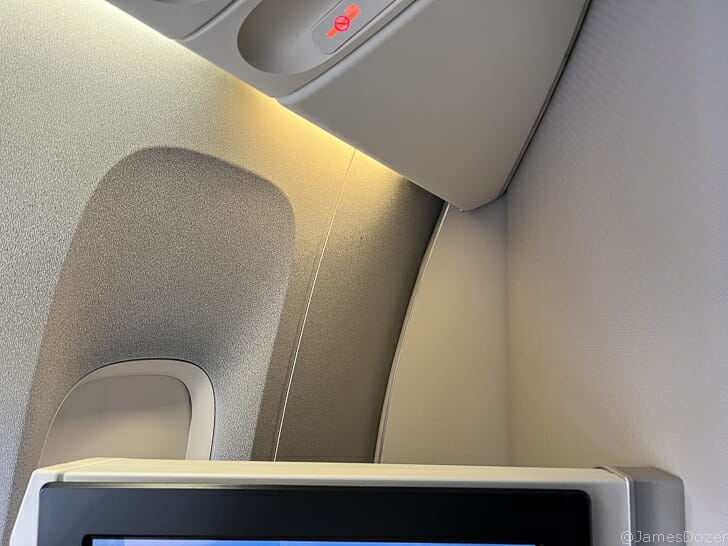 a tv and a light on the side of a plane