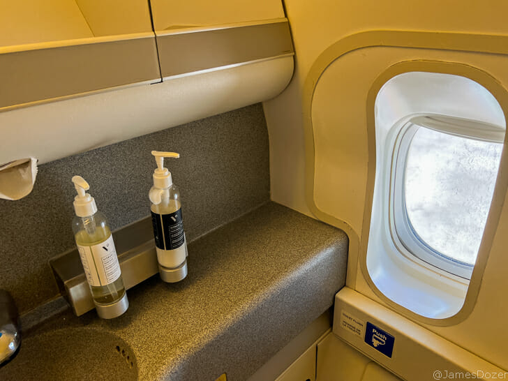 a sink with soap dispensers on a counter top
